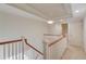 Upstairs hallway featuring wood railing, neutral walls, carpet flooring and recessed lighting at 5808 Deer Crossing Dr, Sugar Hill, GA 30518