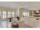 Charming kitchen with a breakfast nook features bar stool seating, white cabinets and countertops, and stainless steel appliances at 5808 Deer Crossing Dr, Sugar Hill, GA 30518