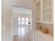 Bright eat-in kitchen boasts an island, tile floors, white cabinets and appliances, and a clear view of the dining area at 5808 Deer Crossing Dr, Sugar Hill, GA 30518