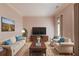 Cozy living room with neutral tones, plush seating, and large windows for ample light at 5808 Deer Crossing Dr, Sugar Hill, GA 30518