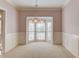 Bright living room featuring neutral walls, carpet, and a large bay window at 5808 Deer Crossing Dr, Sugar Hill, GA 30518