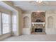 Bright living room featuring neutral walls, carpet, fireplace and a large window at 5808 Deer Crossing Dr, Sugar Hill, GA 30518