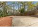 Backyard with parking pad has wooded view and privacy fence with natural sunlight at 2051 Candlewood Ne Ct, Marietta, GA 30066