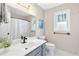 Well-lit bathroom with a white vanity top, modern fixtures, and natural light from a window at 2051 Candlewood Ne Ct, Marietta, GA 30066