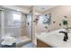 This renovated bathroom features a sleek glass shower, modern fixtures, and double vanity at 2051 Candlewood Ne Ct, Marietta, GA 30066