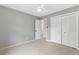 Neutral bedroom with a ceiling fan and a large closet with bi-fold doors at 2051 Candlewood Ne Ct, Marietta, GA 30066
