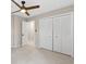 Spacious bedroom featuring a ceiling fan and a large closet with bi-fold doors at 2051 Candlewood Ne Ct, Marietta, GA 30066