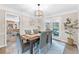 Formal dining room features modern lighting, seating for six, with french doors leading to the exterior at 2051 Candlewood Ne Ct, Marietta, GA 30066