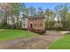 Charming brick two-story home with a manicured lawn and a paved driveway with mature trees at 2051 Candlewood Ne Ct, Marietta, GA 30066