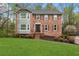 Charming brick two-story home with a manicured lawn, gray siding and complementary brown shutters at 2051 Candlewood Ne Ct, Marietta, GA 30066