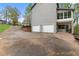 Home exterior with convenient garage and access to main level with beautiful stone steps and wooded view at 2051 Candlewood Ne Ct, Marietta, GA 30066