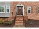 Close-up of the front entrance with a brick staircase and decorative trim on the beautiful wood door at 2051 Candlewood Ne Ct, Marietta, GA 30066