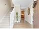 Light and bright hallway with wood floors, staircase and decorative plant, creating a welcoming entry at 2051 Candlewood Ne Ct, Marietta, GA 30066