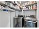Convenient laundry room features modern appliances, with shelving for easy organization of supplies at 2051 Candlewood Ne Ct, Marietta, GA 30066