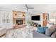 Cozy living room featuring a brick fireplace, a ceiling fan and large windows at 2051 Candlewood Ne Ct, Marietta, GA 30066