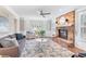 Bright living room featuring a brick fireplace, large windows, and comfortable seating arrangement at 2051 Candlewood Ne Ct, Marietta, GA 30066