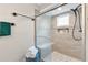 A renovated shower features glass enclosure, tiled walls, and mounted shower head with seating at 2051 Candlewood Ne Ct, Marietta, GA 30066