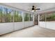 Open screened-in porch with beautiful views and a ceiling fan makes a great space for relaxation and enjoyment at 2051 Candlewood Ne Ct, Marietta, GA 30066