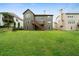 Back exterior elevation showcasing a spacious green lawn and deck at 4015 Brookhollow Dr, Douglasville, GA 30135