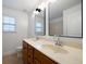 Bathroom with double sinks and granite counters, illuminated by sconces at 4015 Brookhollow Dr, Douglasville, GA 30135