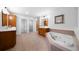 Primary bath with a jacuzzi tub, double sinks, and plenty of storage at 4015 Brookhollow Dr, Douglasville, GA 30135