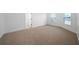 Spacious bedroom with carpet flooring, two windows, and neutral paint at 4015 Brookhollow Dr, Douglasville, GA 30135
