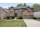 Charming brick home featuring manicured landscaping, a two-car garage, and a welcoming front entrance at 4015 Brookhollow Dr, Douglasville, GA 30135
