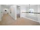 A bright hallway with carpet, a window, and white railings at 4015 Brookhollow Dr, Douglasville, GA 30135