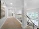 Light-filled hallway with carpet and a staircase leading to the lower level at 4015 Brookhollow Dr, Douglasville, GA 30135