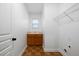 Small laundry room features a sink, cabinet, and wire rack shelving at 4015 Brookhollow Dr, Douglasville, GA 30135
