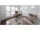 Office features bright, natural light, wood floors, neutral walls, and modern furniture at 4015 Brookhollow Dr, Douglasville, GA 30135
