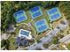 Aerial view of community tennis courts and pool with parking and greenery at 4015 Brookhollow Dr, Douglasville, GA 30135