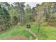 Aerial view of landscaped backyard, with stone path, trampoline, and storage shed at 417 Wood Branch St, Woodstock, GA 30188