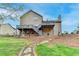 Grassy backyard featuring a stone pathway and a multi-level deck, creating an ideal space for outdoor enjoyment at 417 Wood Branch St, Woodstock, GA 30188