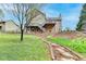 Spacious backyard with a stone pathway leading to a house with a deck and play area at 417 Wood Branch St, Woodstock, GA 30188