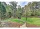 Large backyard featuring stone path, playground equipment, storage shed, and natural landscaping, great for outdoor activities at 417 Wood Branch St, Woodstock, GA 30188
