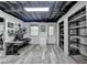 Finished basement features shelving, computer desk, and gray wood-look flooring at 417 Wood Branch St, Woodstock, GA 30188