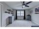 This bedroom features a grey color palette, ceiling fan, and superhero themed wall art at 417 Wood Branch St, Woodstock, GA 30188