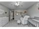 This bedroom features a grey color palette, ceiling fan, and an accent wall at 417 Wood Branch St, Woodstock, GA 30188