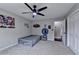 This bedroom features a grey color palette, ceiling fan, carpet, and superhero themed wall art at 417 Wood Branch St, Woodstock, GA 30188