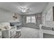 This bedroom features a grey color palette with accents of soft pink and white, and natural light at 417 Wood Branch St, Woodstock, GA 30188