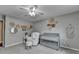 This bedroom features a grey color palette, ceiling fan, and an accent wall at 417 Wood Branch St, Woodstock, GA 30188