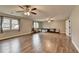 Large bonus room with wood floors, ceiling fans, natural light and a cozy play area at 417 Wood Branch St, Woodstock, GA 30188