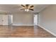 Open bonus room with beautiful wood floors, neutral colors, and access to other rooms at 417 Wood Branch St, Woodstock, GA 30188