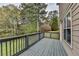 View of the home's wooden deck with gray stain and view of the yard at 417 Wood Branch St, Woodstock, GA 30188