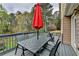 The outdoor deck features patio furniture, a red umbrella, and a view of the backyard at 417 Wood Branch St, Woodstock, GA 30188
