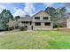 Charming two-story home with a well-manicured lawn and mature trees at 417 Wood Branch St, Woodstock, GA 30188