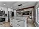 Spacious kitchen with stainless steel appliances, a large island, white cabinets, and open to dining area at 417 Wood Branch St, Woodstock, GA 30188