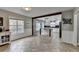Open kitchen boasts a large island, stainless steel appliances, white cabinets, black backsplash and wood beam accents at 417 Wood Branch St, Woodstock, GA 30188
