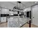 Open concept kitchen features stainless steel appliances, a large island, and white cabinets at 417 Wood Branch St, Woodstock, GA 30188